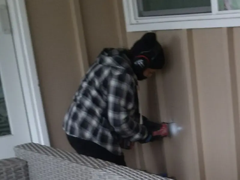 Professional electrician installing an exterior outlet in Middlesex