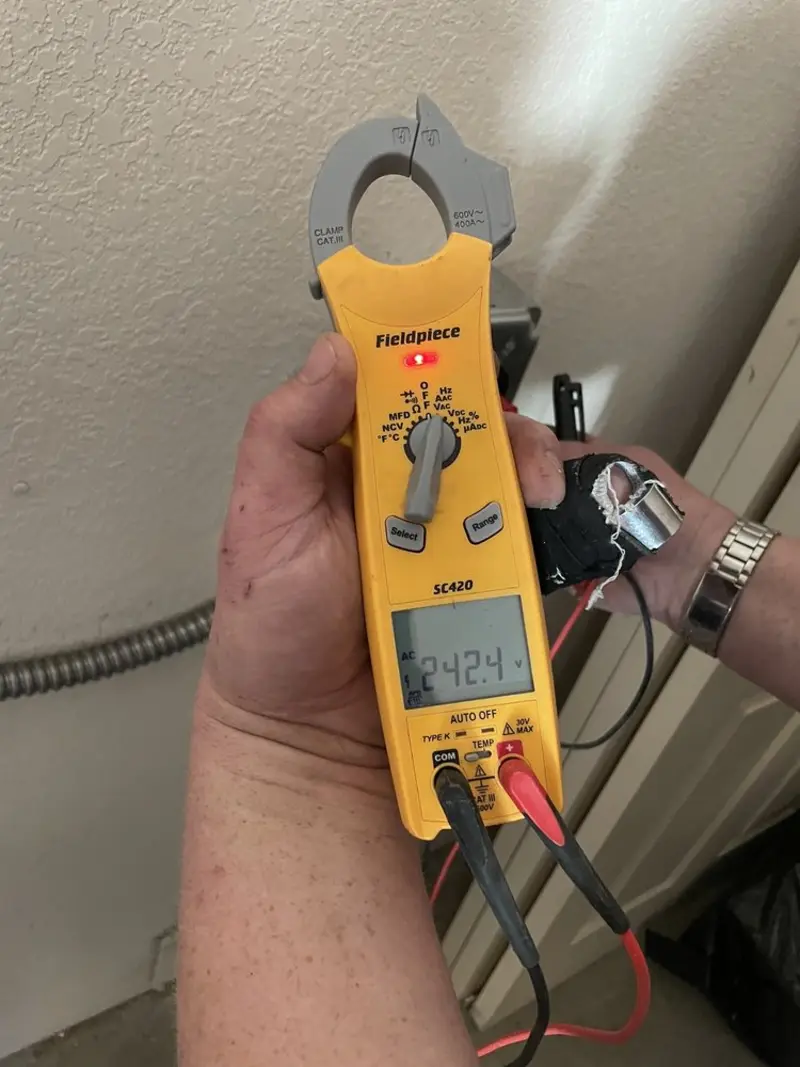 Voltage testing with clamp meter during Whole House Surge Protector in Middlesex